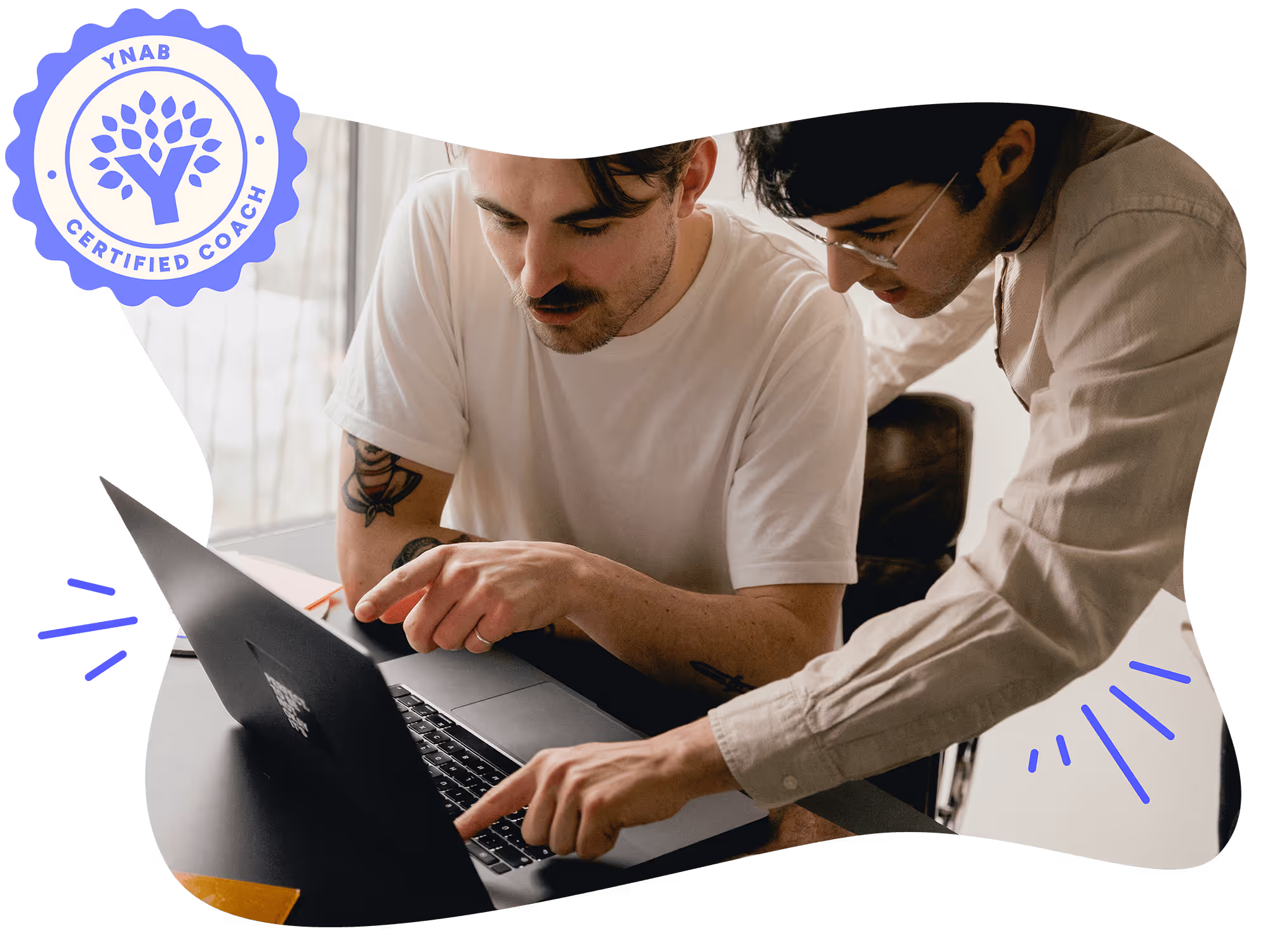 Two men talking and pointing at a laptop